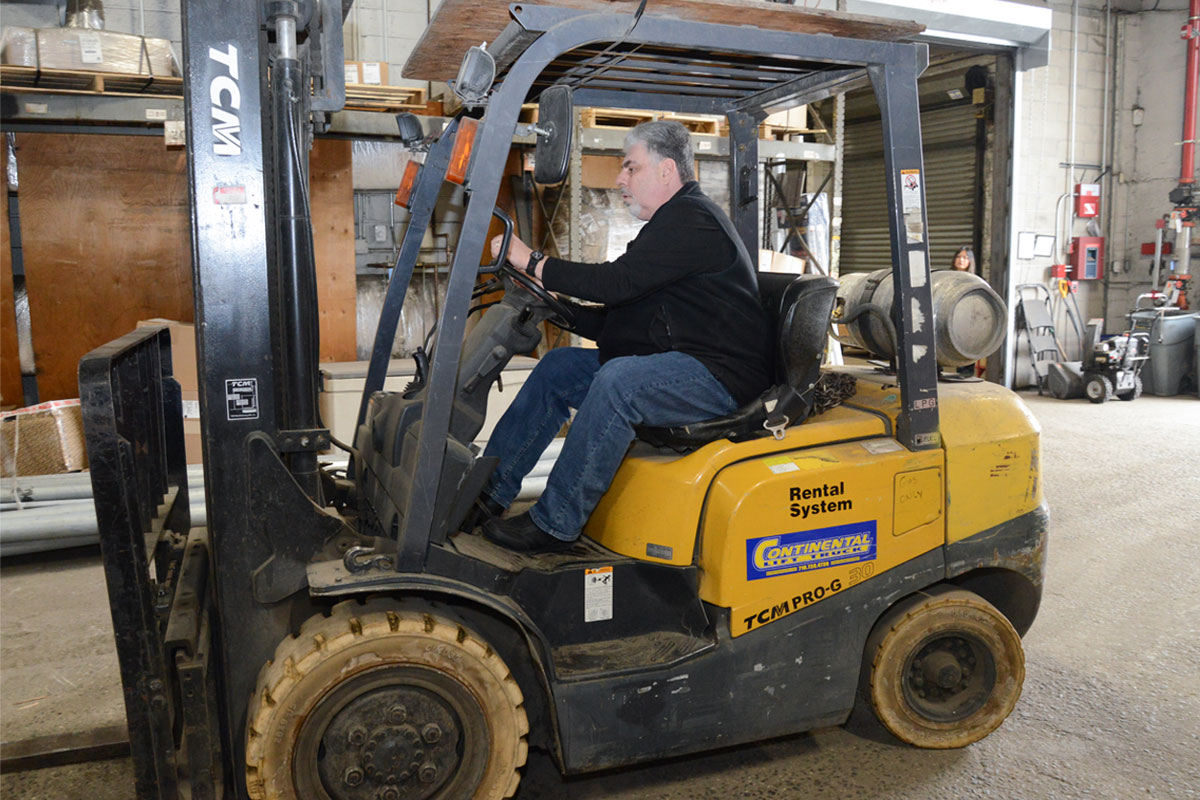 Employee driving a forklift