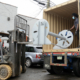 Using forklift to place heavy object inside a semitruck.