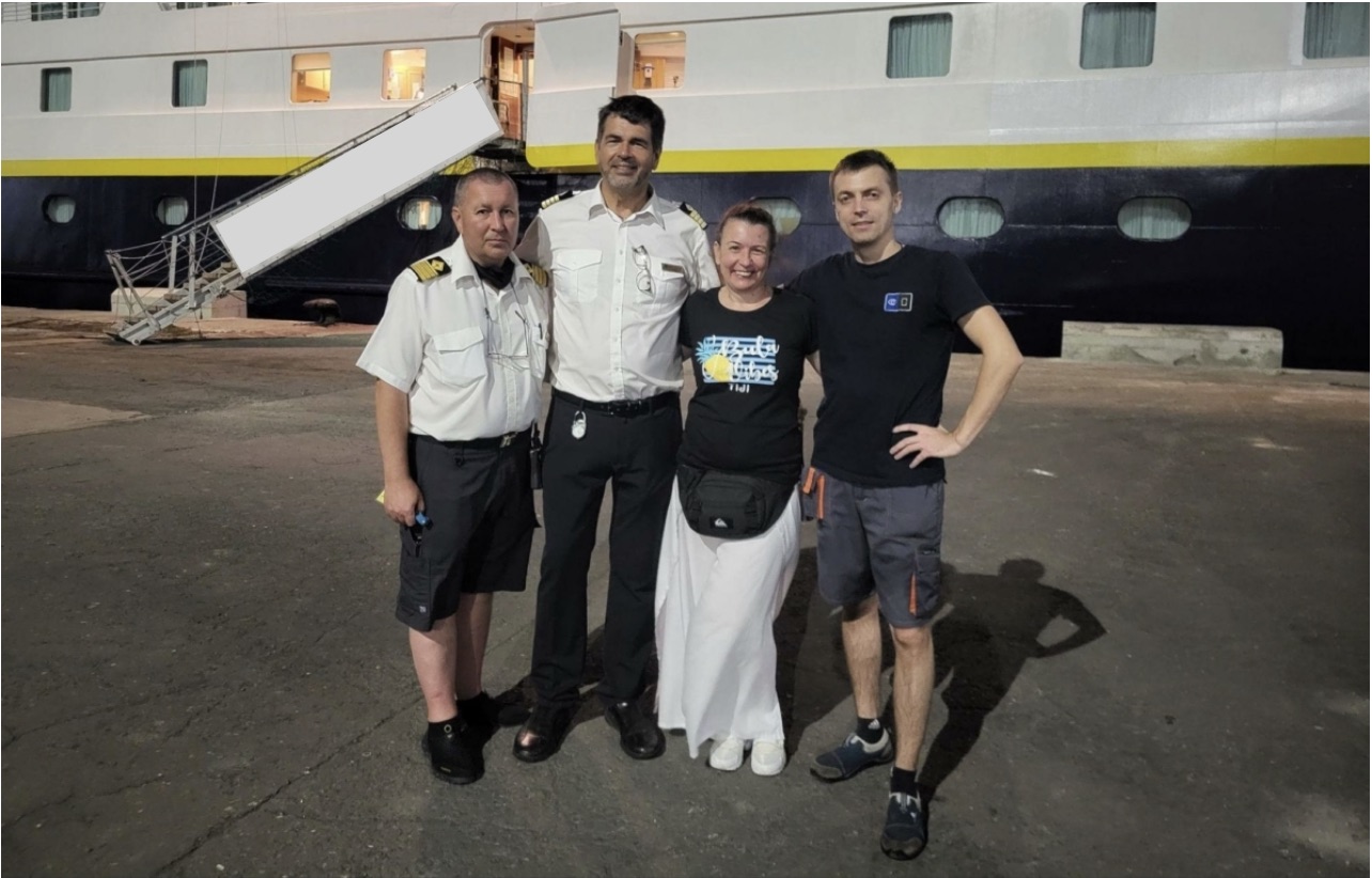 group photo in front of ship