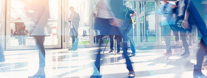 Busy professionals walking in a building.