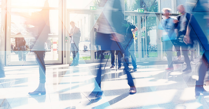 Busy professionals walking in a building.